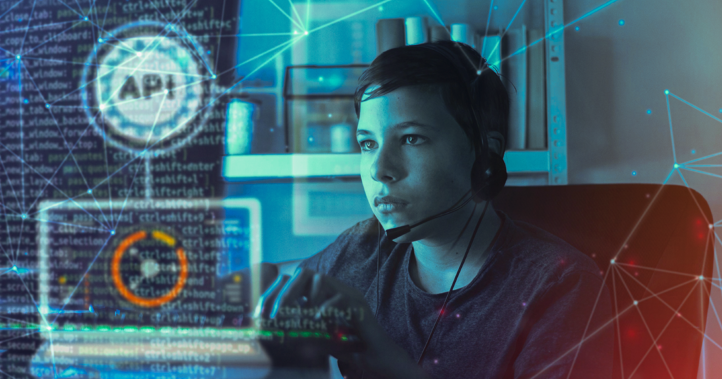 A young boy wearing headphones and working on APIs