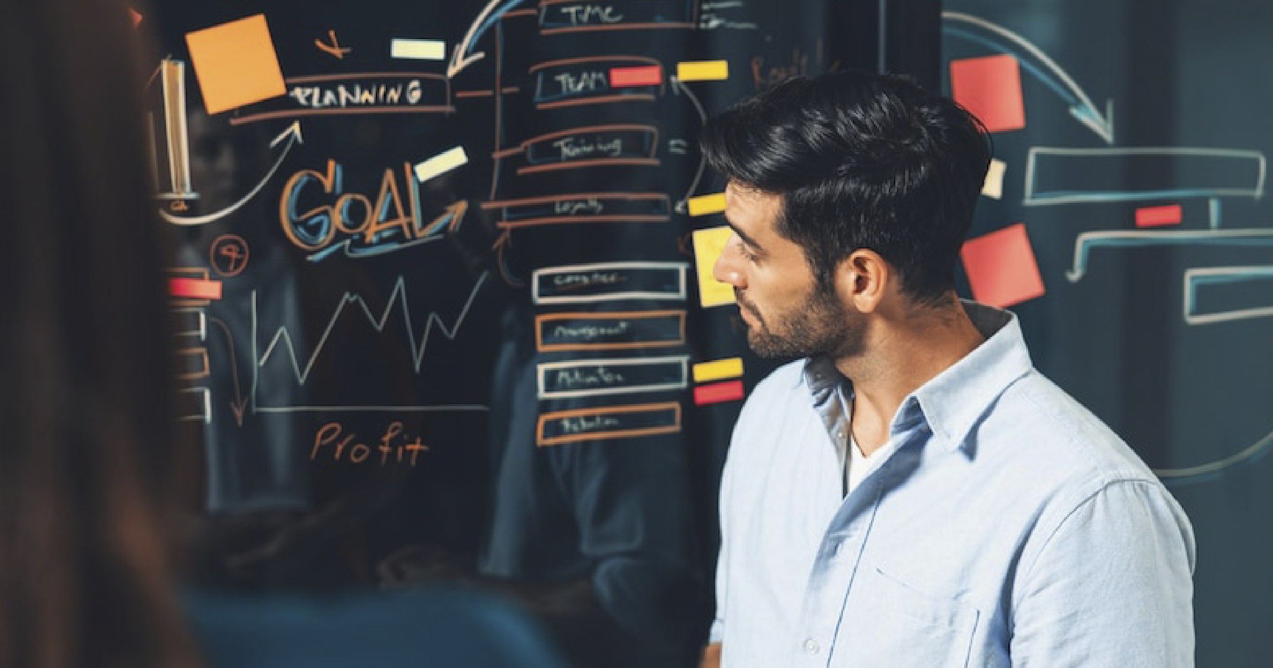 Person is analysing metrics on a board.