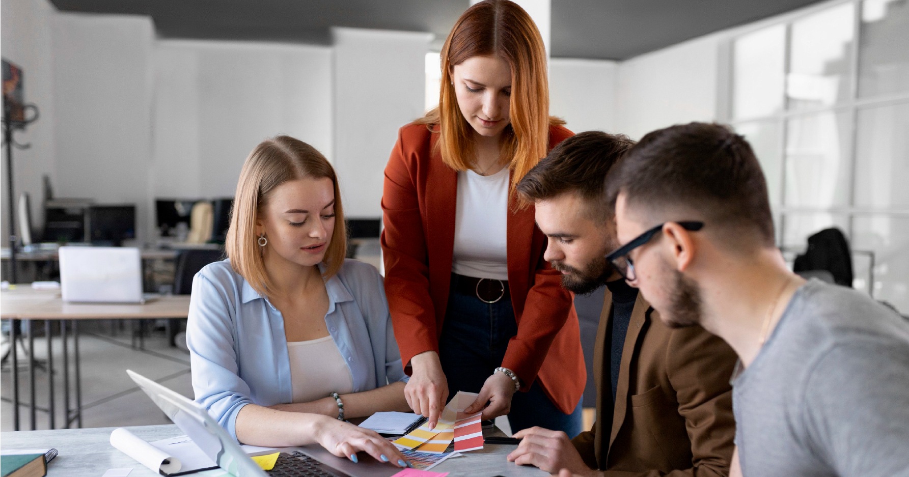group of four people discussing about ui ux 